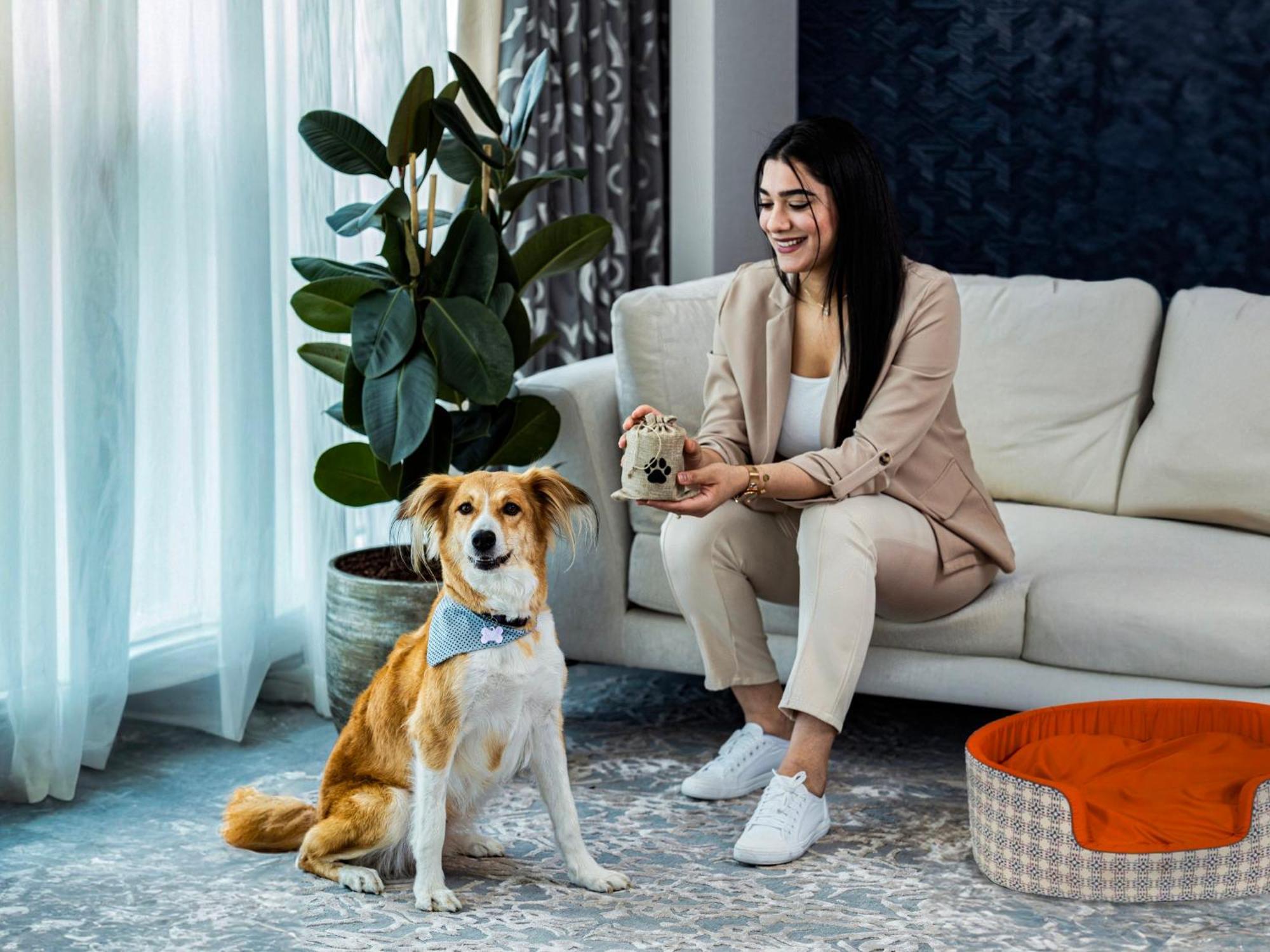 Abesq Doha Hotel And Residences, An Ihg Hotel Exteriör bild A dog with its owner
